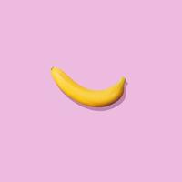 Banana close-up isolated on pink background. Photo with copy space.