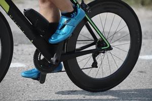 closeup of triathlon athlete riding bike photo