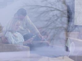 Couple using digital tablet on cold winter day photo