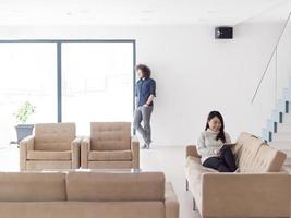 multiethnic couple at home using tablet computers photo