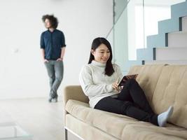 multiethnic couple at home using tablet computers photo