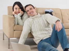 happy multiethnic couple relaxing at home photo