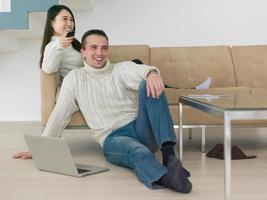 multiethnic couple on the sofa watching television photo