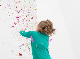 kid blowing confetti photo