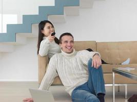 multiethnic couple on the sofa watching television photo