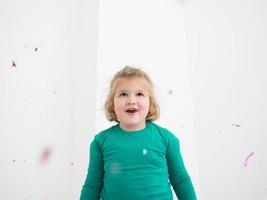 kid blowing confetti photo