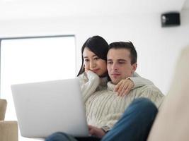 multiethnic couple using laptop computers photo