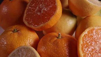 Fruits rotating. This stock video features oranges, mandarin, grapefruit slowly rotating on a black background.