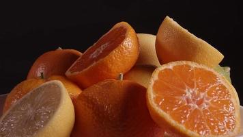 Fruits rotating. This stock video features oranges, mandarin, grapefruit slowly rotating on a black background.