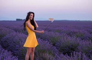 couple in lavender field using smartphone photo