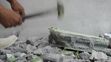 Worker using hammer hit concrete for break it to be small fractal construction concept video