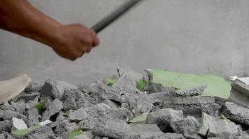 Worker using hammer hit concrete for break it to be small fractal construction concept video