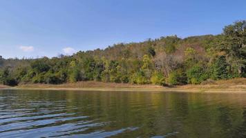 vue sur le bateau naviguant et se déplaçant dans la grande rivière avec la nature forêt tropicale video