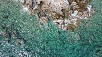 A bird's eye view of a stunning nature reserve, with rocky outcrops, coral reefs and lush vegetation. video