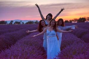 group of famales have fun in lavender flower field photo