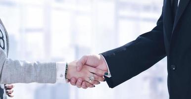 Businessman and businesswoman shaking hands after meetup photo