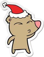sticker cartoon of a whistling bear wearing santa hat vector