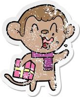 distressed sticker of a crazy cartoon monkey with christmas present vector