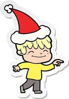 sticker cartoon of a happy boy wearing santa hat vector