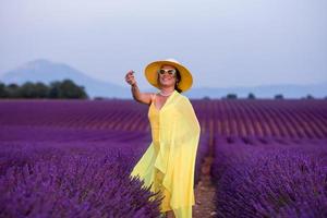 asian woman in yellow dress and hat at lavender field photo