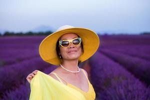 asian woman in yellow dress and hat at lavender field photo