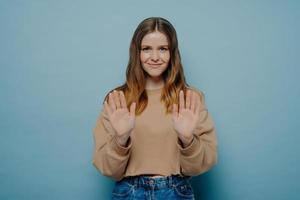 Young smiling brunette woman making no gesture photo