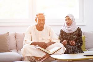 african couple at home reading quran photo