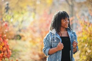 Stylish trendy afro france curly woman posed at autumn day in jeans jacket. Black african female model. photo