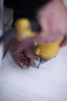 repairman working with drilling machine photo