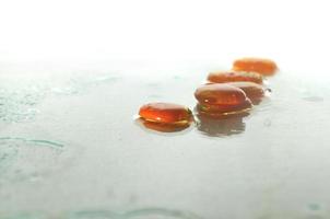 isolated wet zen stones with splashing  water drops photo