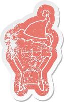 bored bear cartoon distressed sticker of a wearing santa hat vector