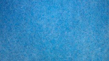 textura azul en forma de fibras duras. la estructura de la esponja de lavado corporal. fondo suave tratamientos de agua y spa. posicion horizontal. foto
