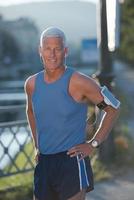 portrait of handsome senior jogging man photo