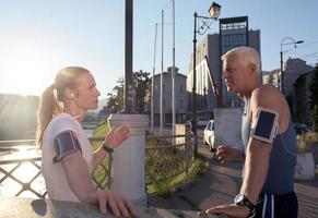 jogging couple planning running route  and setting music photo