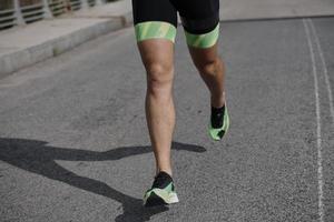 triathlon athlete running on street photo