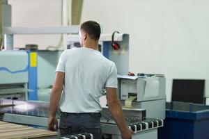 worker in a factory of wooden furniture photo