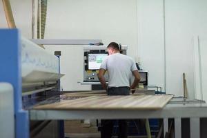 worker in a factory of wooden furniture photo