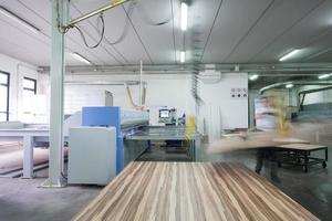 worker in a factory of wooden furniture photo