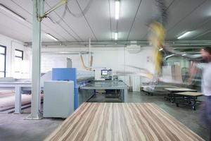 worker in a factory of wooden furniture photo