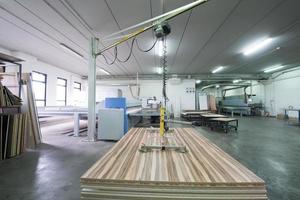 worker in a factory of wooden furniture photo