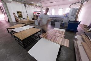 worker in a factory of wooden furniture photo