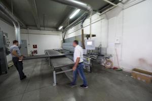 workers in a factory of wooden furniture photo