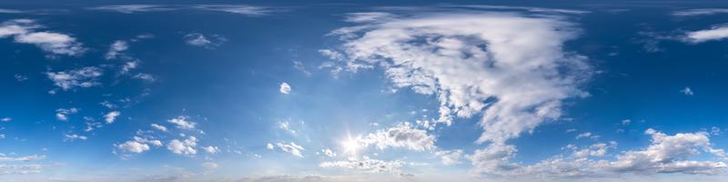 blue sky with beautiful fluffy cumulus clouds. Seamless hdri panorama 360 degrees angle view without ground for use in 3d graphics or game development as sky dome or edit drone shot photo