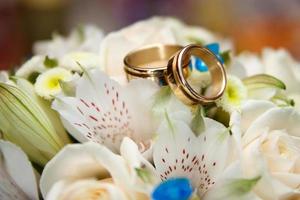 bright wedding bouquet of summer flowers  with wedding rings