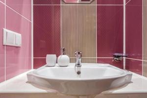 Soap and shampoo dispensers near Ceramic Water tap sink with faucet in expensive loft bathroom photo