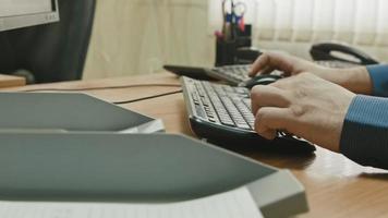 Hands of worker working at computer video