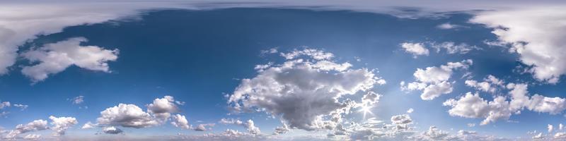 blue sky with beautiful fluffy cumulus clouds. Seamless hdri panorama 360 degrees angle view without ground for use in 3d graphics or game development as sky dome or edit drone shot photo