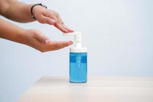 Close up woman washing hands with alcohol gel sanitizer with copy space for prevent the spread of pandemic Covid-19 and Coronavirus, healthcare and hygiene concept photo