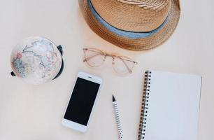 Flat lay of travel items and accessories with notebook in minimal style photo