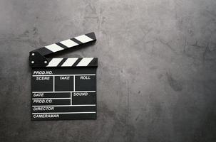 Empty clapperboard in flat lay style on dark stone background with copy space, entertainment and cinema industry